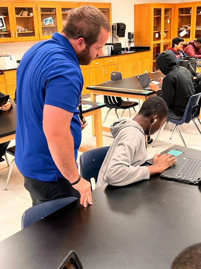 Coach Ryan Sisco assists an environmental systems student with an assignment.